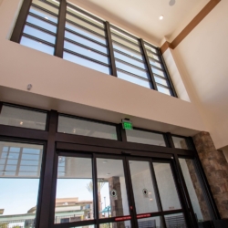 Revel Nevada - Storefront Glass System shot from Interior, Transom Windows (Above) and Double Sliding Automatic Glass Door System Installed By A Cutting Edge Glass and Mirror