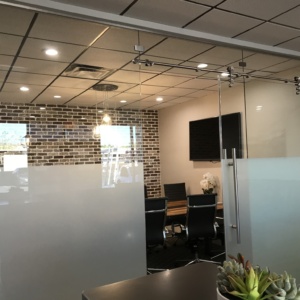 Glass wall system with barn door and ladder pull handle