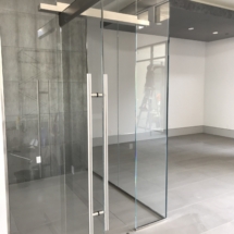 Wine cellar with polished stainless steel hardware and 5/8 strap hire tempered glass