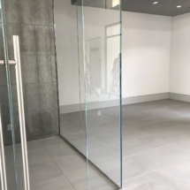 Wine cellar with polished stainless steel hardware and 5/8 strap hire tempered glass