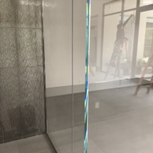 Wine cellar with polished stainless steel hardware and 5/8 strap hire tempered glass